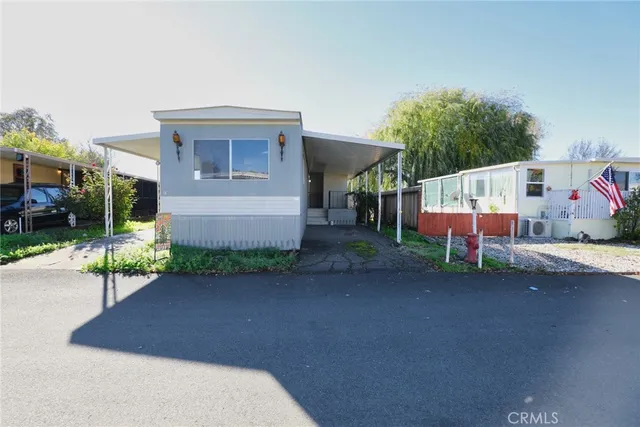 a view of a house with backyard and garage