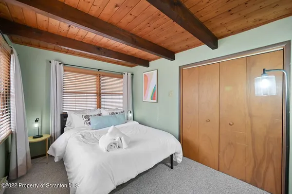 a bedroom with a bed and a mirror