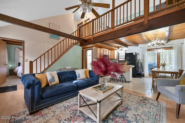 a living room with lots of furniture and a rug