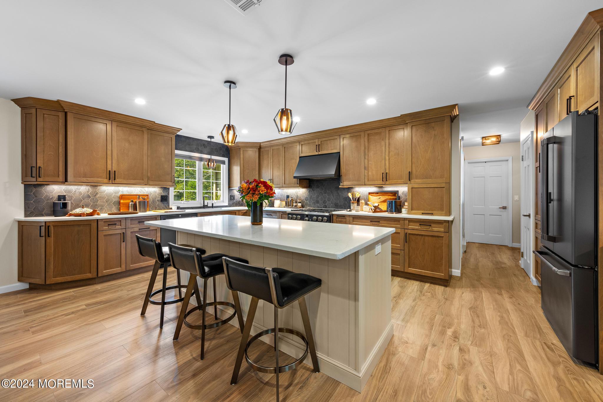343 Easy Street Howell, NJ 07731 - Photo 11 of 53 a kitchen with stainless steel appliances a dining table chairs microwave and sink