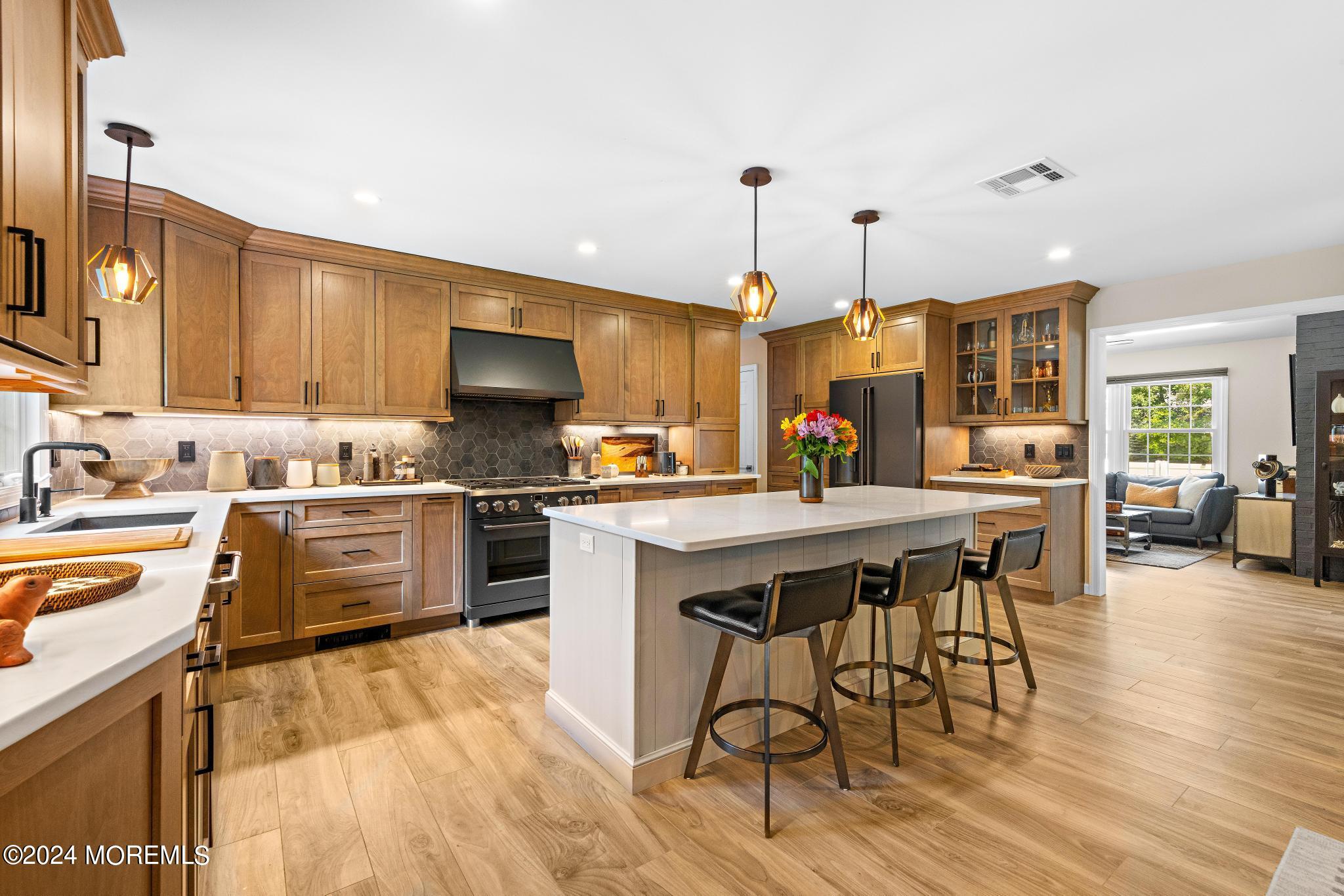 343 Easy Street Howell, NJ 07731 - Photo 12 of 53 a kitchen with stainless steel appliances a stove a sink a oven a dining table and chairs