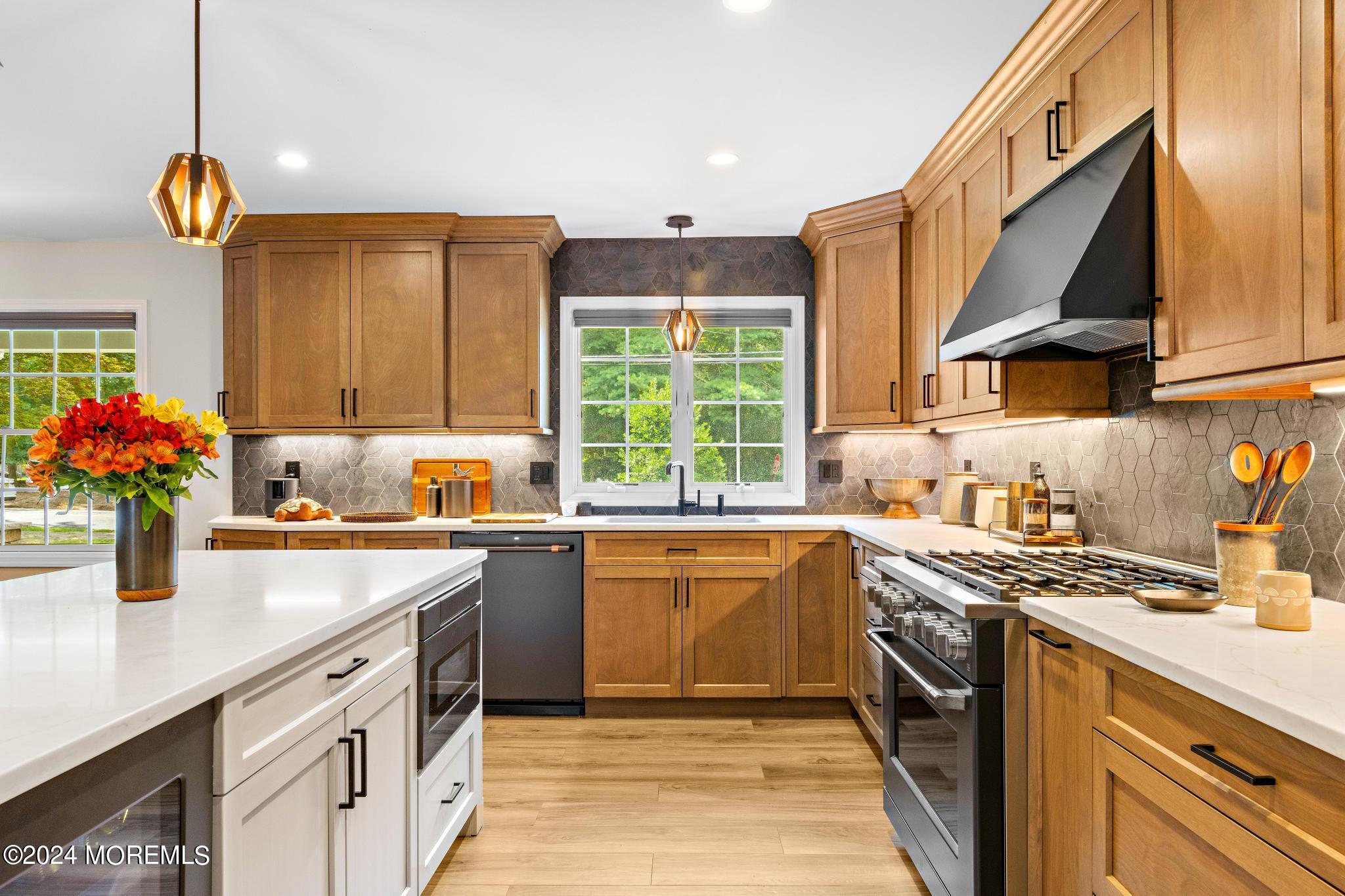 343 Easy Street Howell, NJ 07731 - Photo 16 of 53 a kitchen with stainless steel appliances granite countertop a sink stove and cabinets