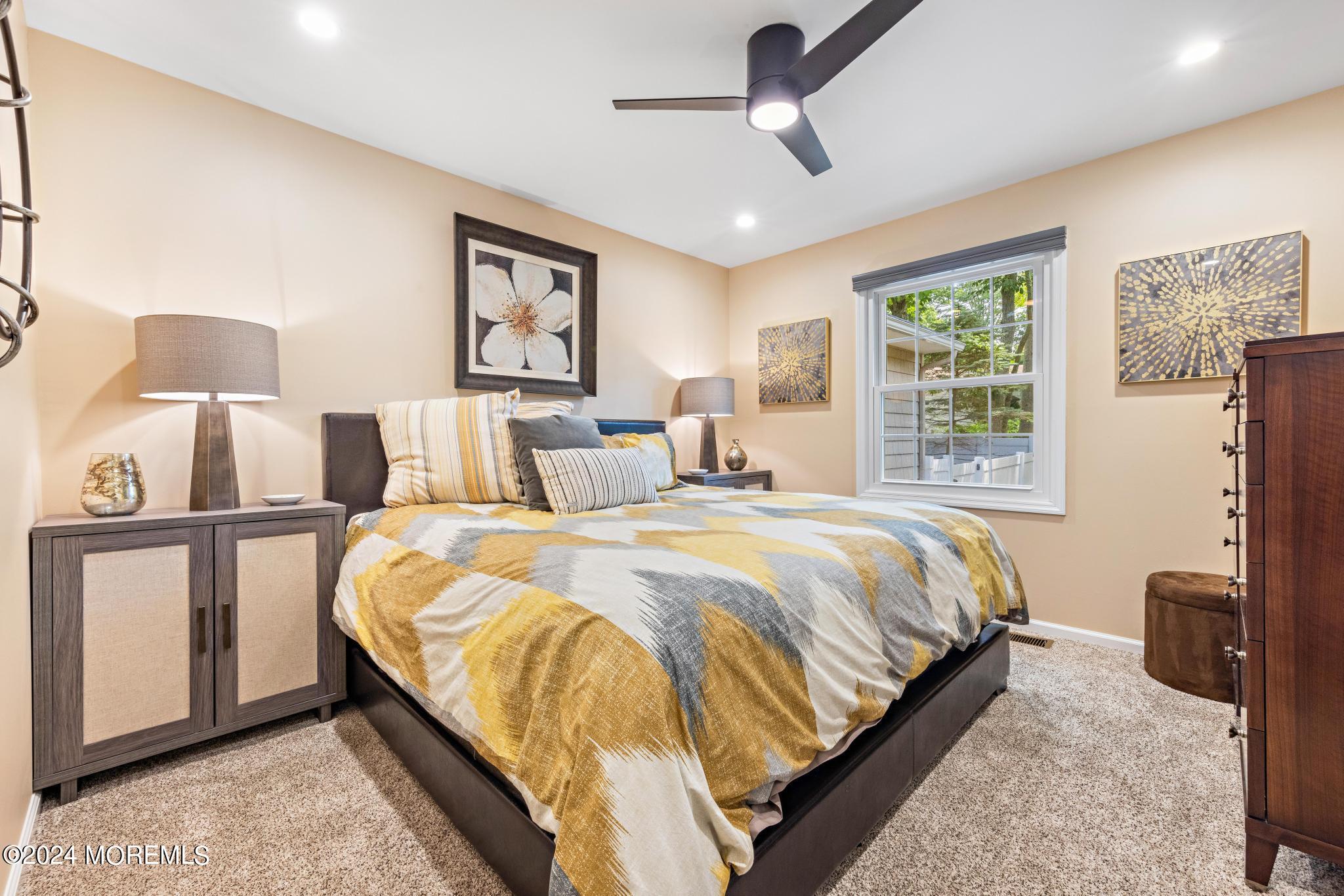 343 Easy Street Howell, NJ 07731 - Photo 27 of 53 a bedroom with a bed lamps and a large mirror