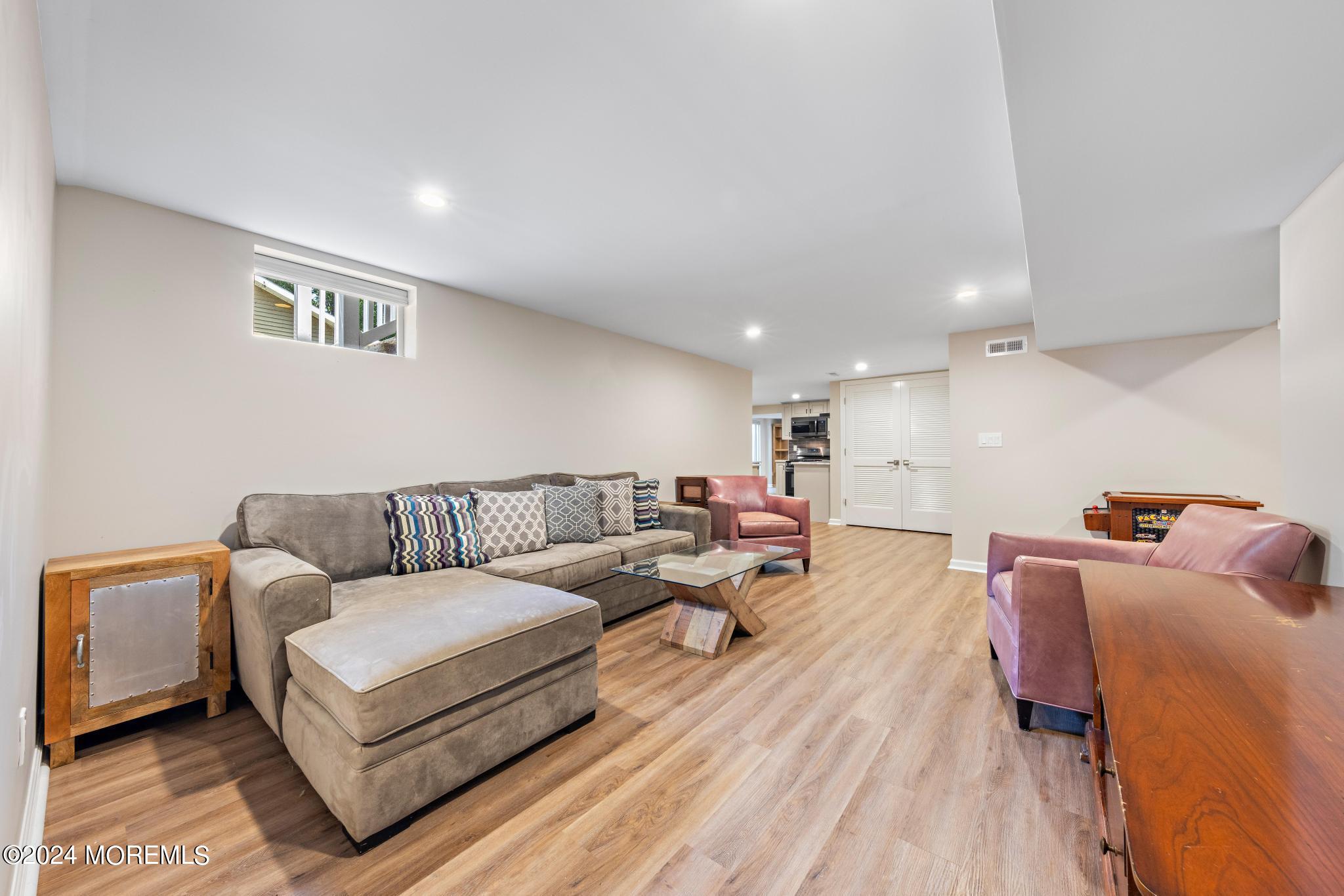 343 Easy Street Howell, NJ 07731 - Photo 32 of 53 a living room with furniture and a wooden floor