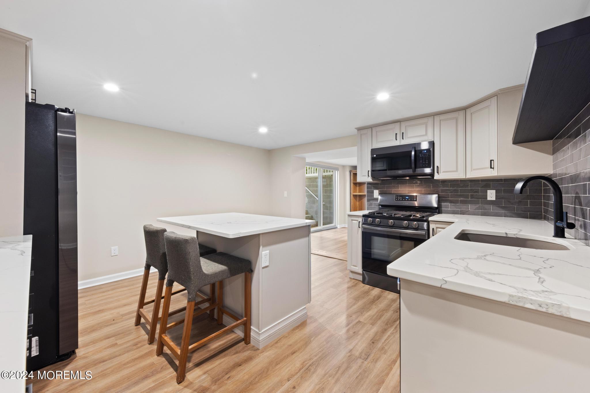 343 Easy Street Howell, NJ 07731 - Photo 37 of 53 a kitchen with stainless steel appliances a stove a sink a microwave a refrigerator and cabinets