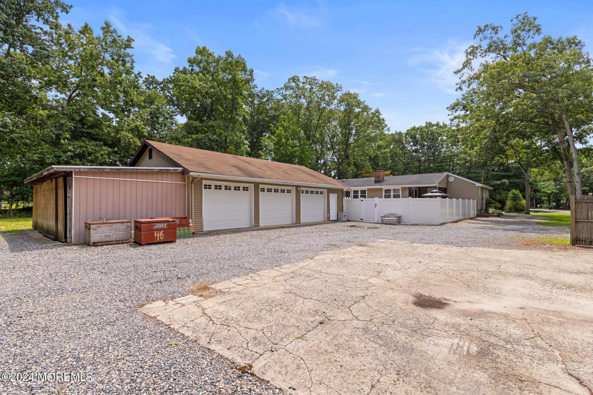 343 Easy Street Howell, NJ 07731 - Photo 46 of 53 a view of a house with a yard and garage