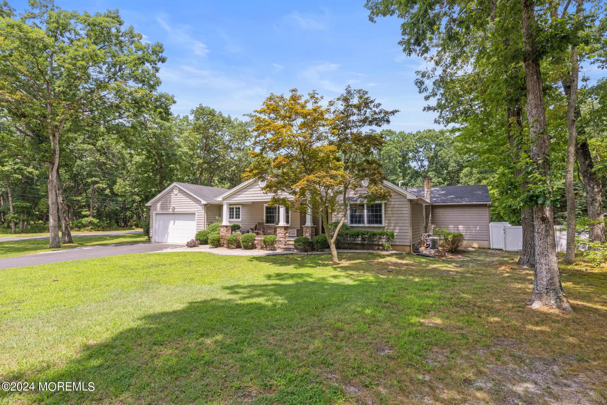 343 Easy Street Howell, NJ 07731 - Photo 50 of 53 a front view of a house with a garden and trees