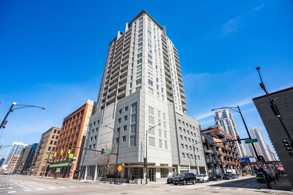a view of a tall building next to a road
