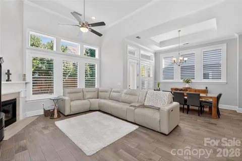 a living room with furniture a fireplace and a large window