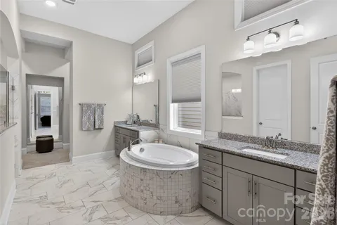 a bathroom with a sink double vanity and a mirror