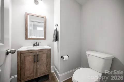 a white toilet sitting next to a bathroom sink