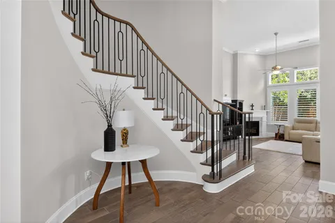 a view of entryway and hall with wooden floor