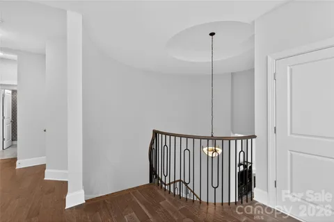a view of hallway with wooden floor