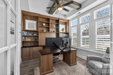 a view of a livingroom with workspace and a window