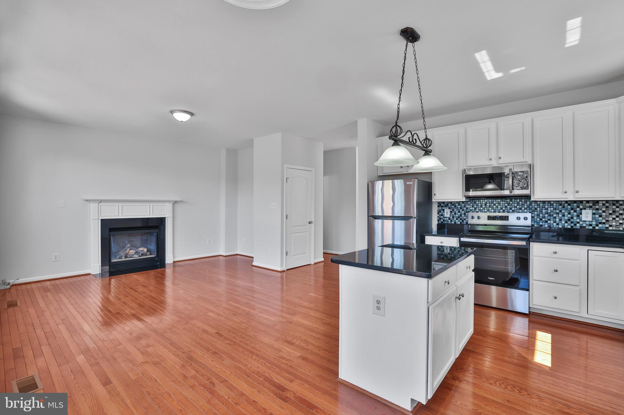 26215 Ocala Circle Chantilly, VA 20152 - Photo 17 of 50 a open kitchen with stainless steel appliances granite countertop a stove a sink dishwasher and a oven with wooden floor