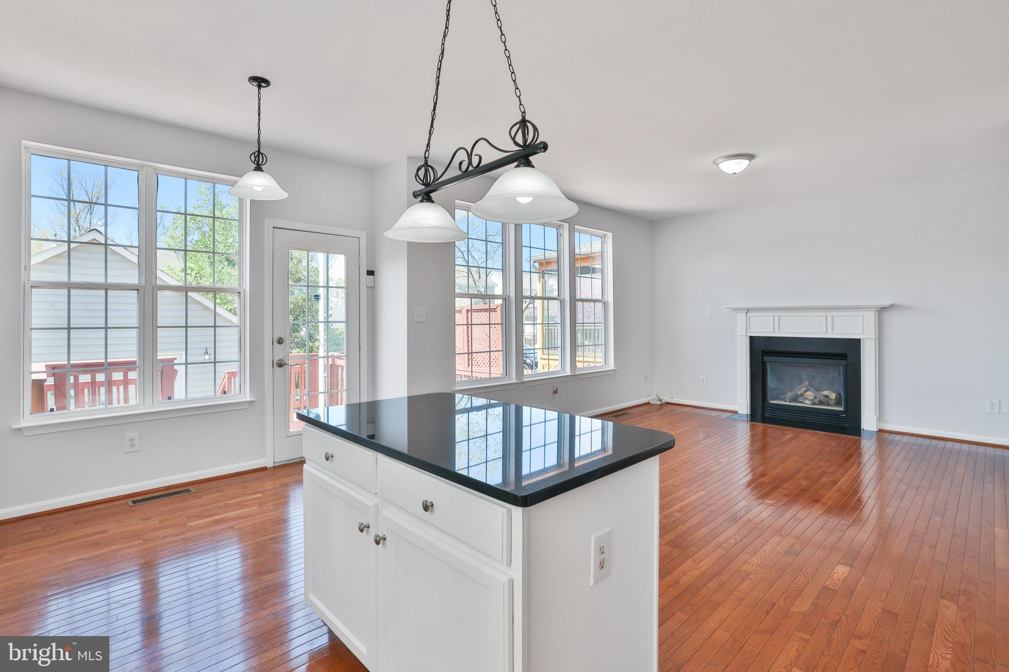26215 Ocala Circle Chantilly, VA 20152 - Photo 19 of 50 a kitchen with granite countertop a stove and a wooden floors