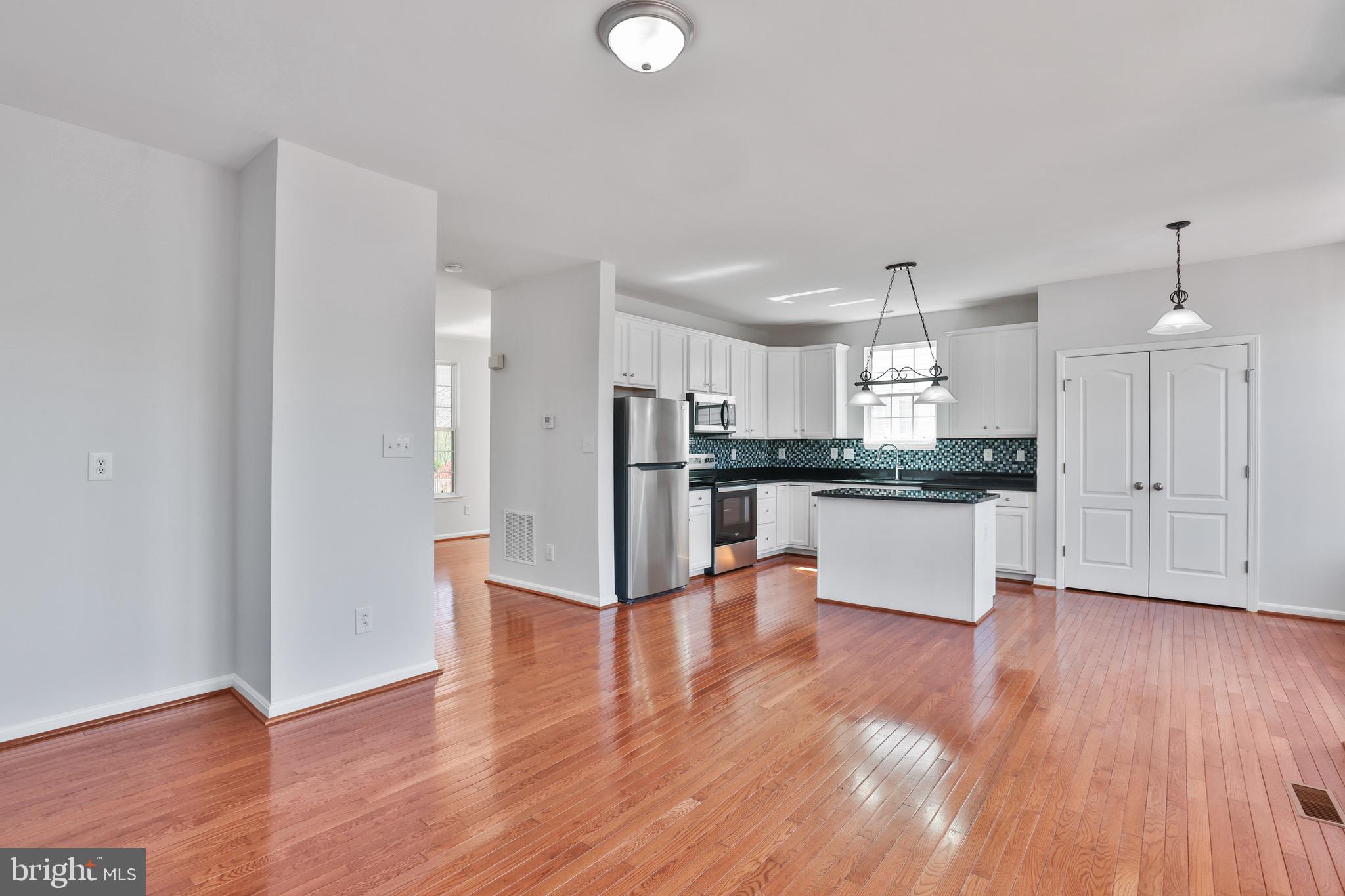 26215 Ocala Circle Chantilly, VA 20152 - Photo 21 of 50 a view of kitchen with refrigerator and wooden floor