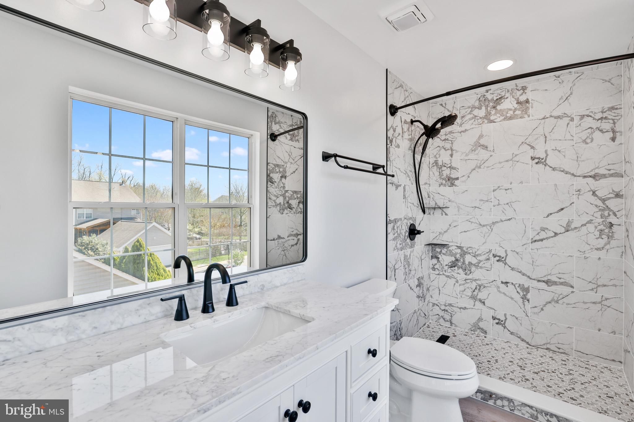 26215 Ocala Circle Chantilly, VA 20152 - Photo 34 of 50 a bathroom with a granite countertop sink a toilet and shower