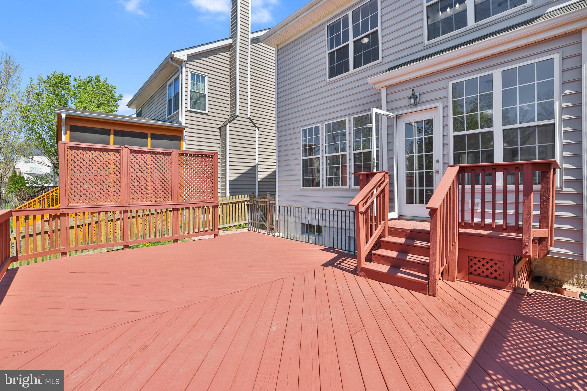 26215 Ocala Circle Chantilly, VA 20152 - Photo 41 of 50 a view of a house with wooden deck and furniture