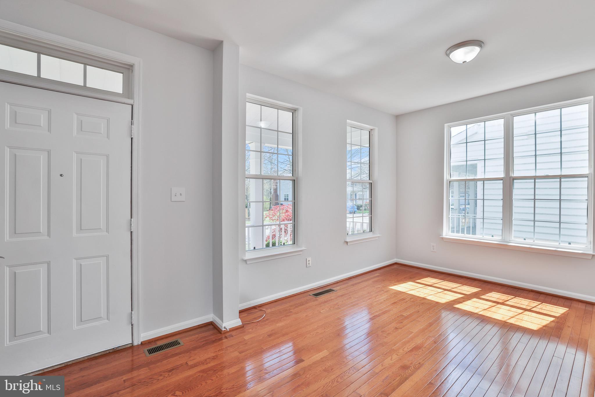 26215 Ocala Circle Chantilly, VA 20152 - Photo 8 of 50 an empty room with wooden floor and windows