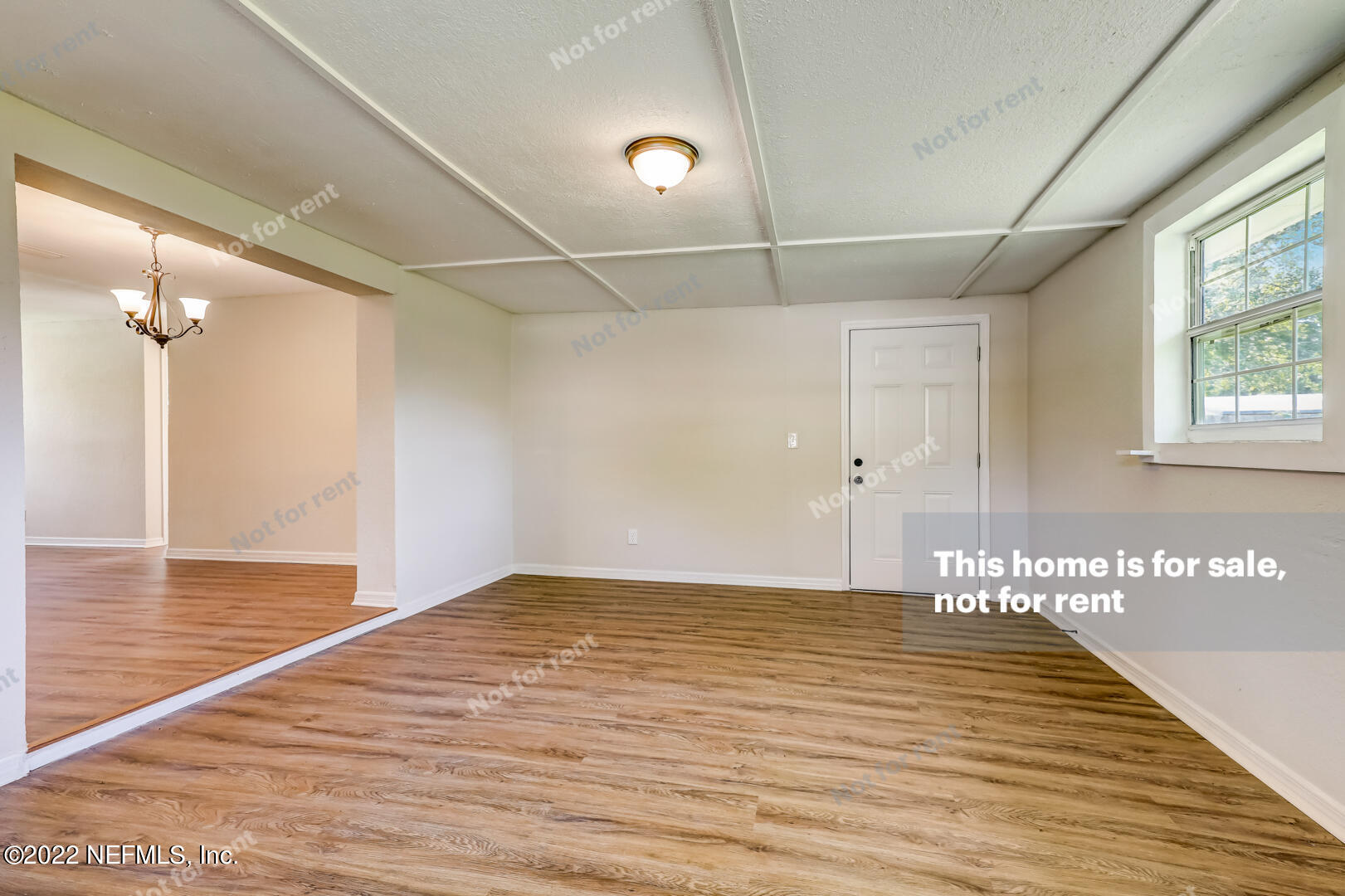 5634 Sabena Road Jacksonville, FL 32207 - Photo 12 of 22 a view of a room with wooden floor and windows