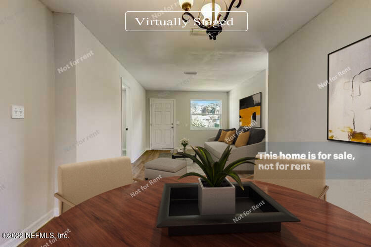 5634 Sabena Road Jacksonville, FL 32207 - Photo 2 of 22 a living room with furniture and a potted plant