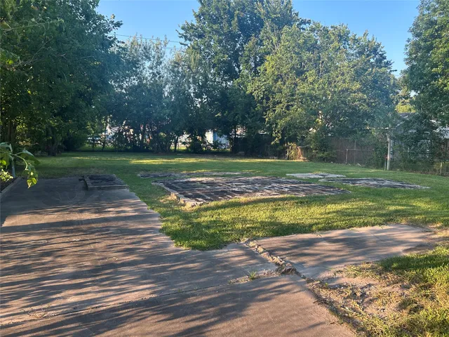 a view of a swimming pool and trees in the background