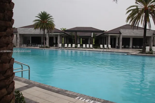 a front view of a house with swimming pool having outdoor seating