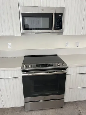 a stove top oven sitting inside of a kitchen