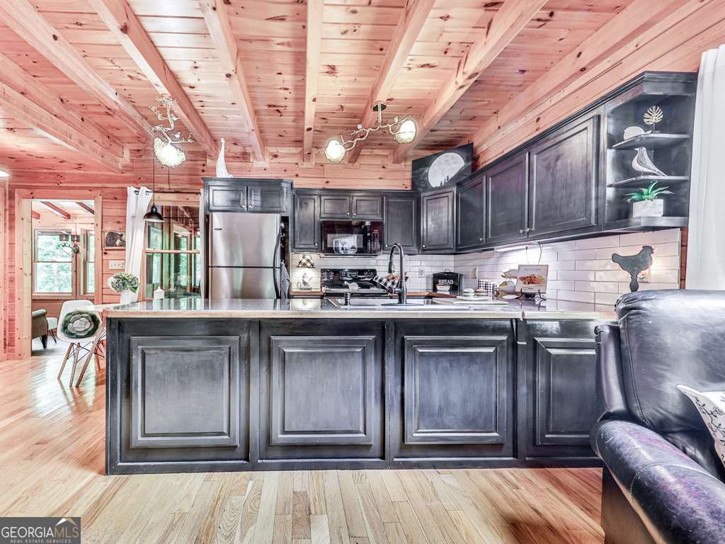 34 Amber Way, Unit 1 Morganton, GA 30560 - Photo 2 of 39 a kitchen with kitchen island granite countertop a sink cabinets and stainless steel appliances
