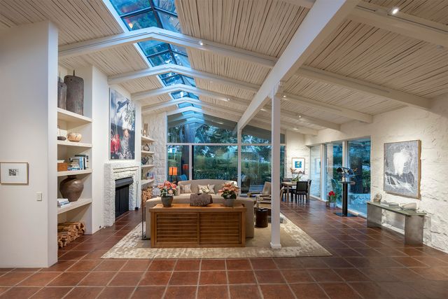 a living room with stainless steel appliances kitchen island granite countertop furniture and a rug