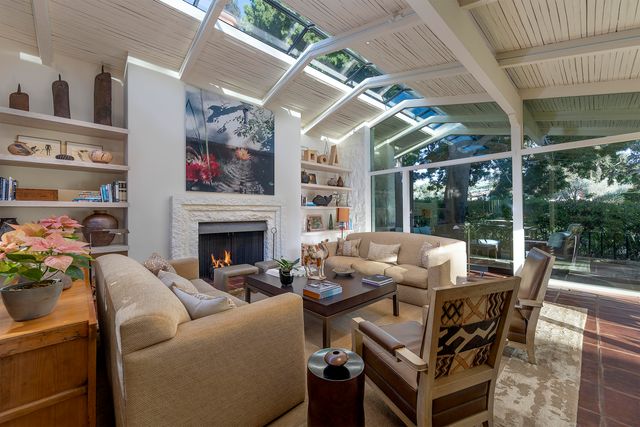 a outdoor living space with furniture potted plant and a large window