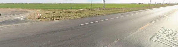 a view of a road with an ocean beach
