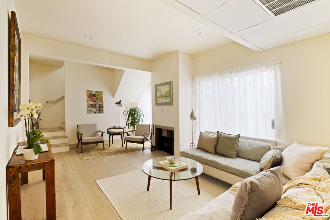 1717 Malcolm Avenue, Unit 303 Los Angeles, CA 90024 - Photo 16 of 34 a living room with furniture and a fireplace