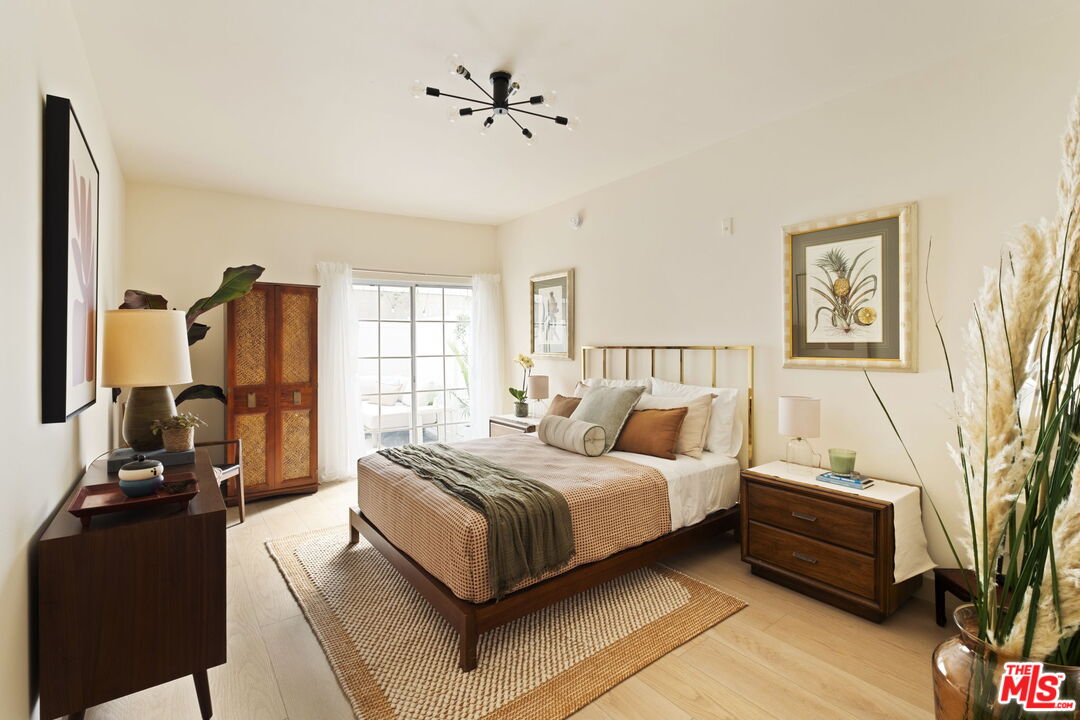 1717 Malcolm Avenue, Unit 303 Los Angeles, CA 90024 - Photo 18 of 34 a spacious bedroom with a bed a couch and a window