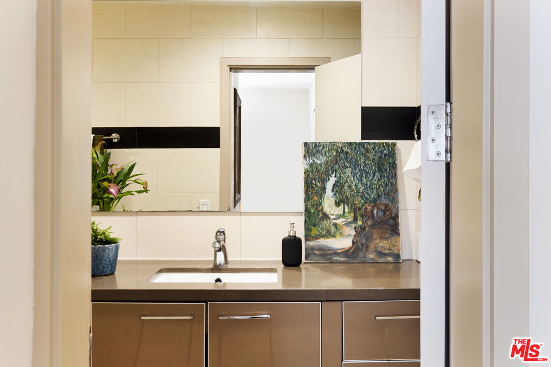 1717 Malcolm Avenue, Unit 303 Los Angeles, CA 90024 - Photo 20 of 34 a bathroom with a sink and a mirror