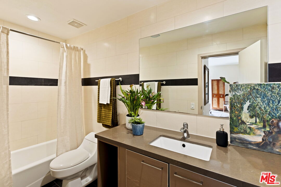 1717 Malcolm Avenue, Unit 303 Los Angeles, CA 90024 - Photo 21 of 34 a bathroom with a sink toilet and shower