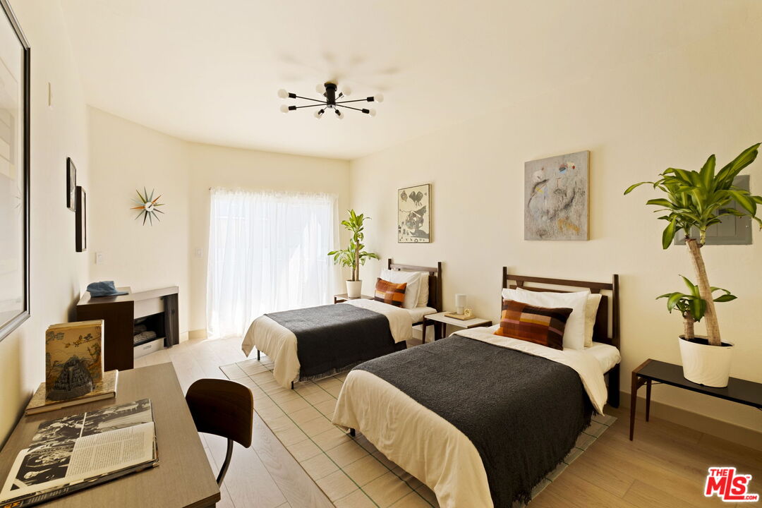 1717 Malcolm Avenue, Unit 303 Los Angeles, CA 90024 - Photo 25 of 34 a bedroom with two beds and a potted plant