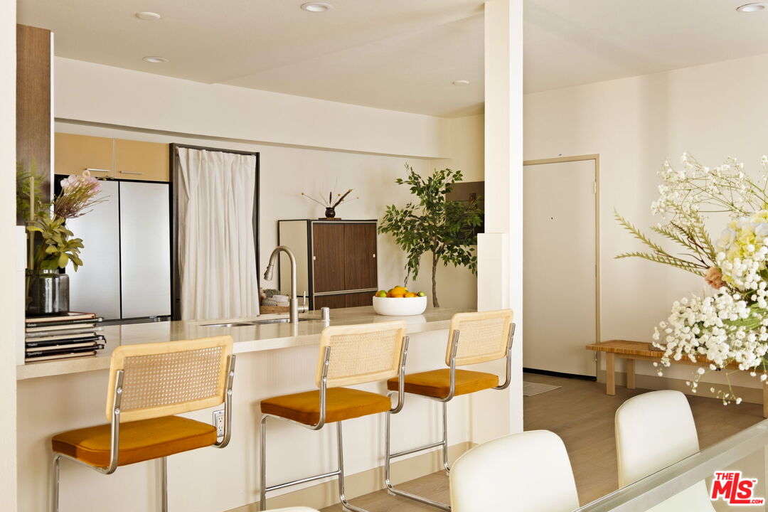 1717 Malcolm Avenue, Unit 303 Los Angeles, CA 90024 - Photo 8 of 34 a dining room with furniture and a flat screen tv