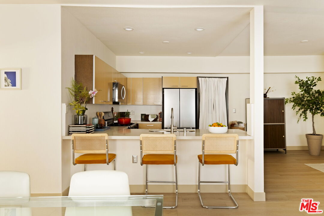 1717 Malcolm Avenue, Unit 303 Los Angeles, CA 90024 - Photo 9 of 34 a large kitchen with a table and chairs