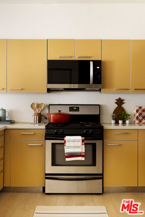 1717 Malcolm Avenue, Unit 303 Los Angeles, CA 90024 - Photo 10 of 34 a kitchen with a stove and a microwave