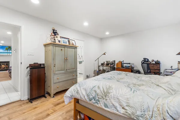 a bedroom with a bed and a dresser