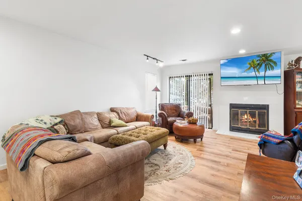 a living room with furniture fireplace and a large window