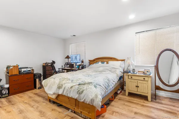 a bed room with a bed and dresser