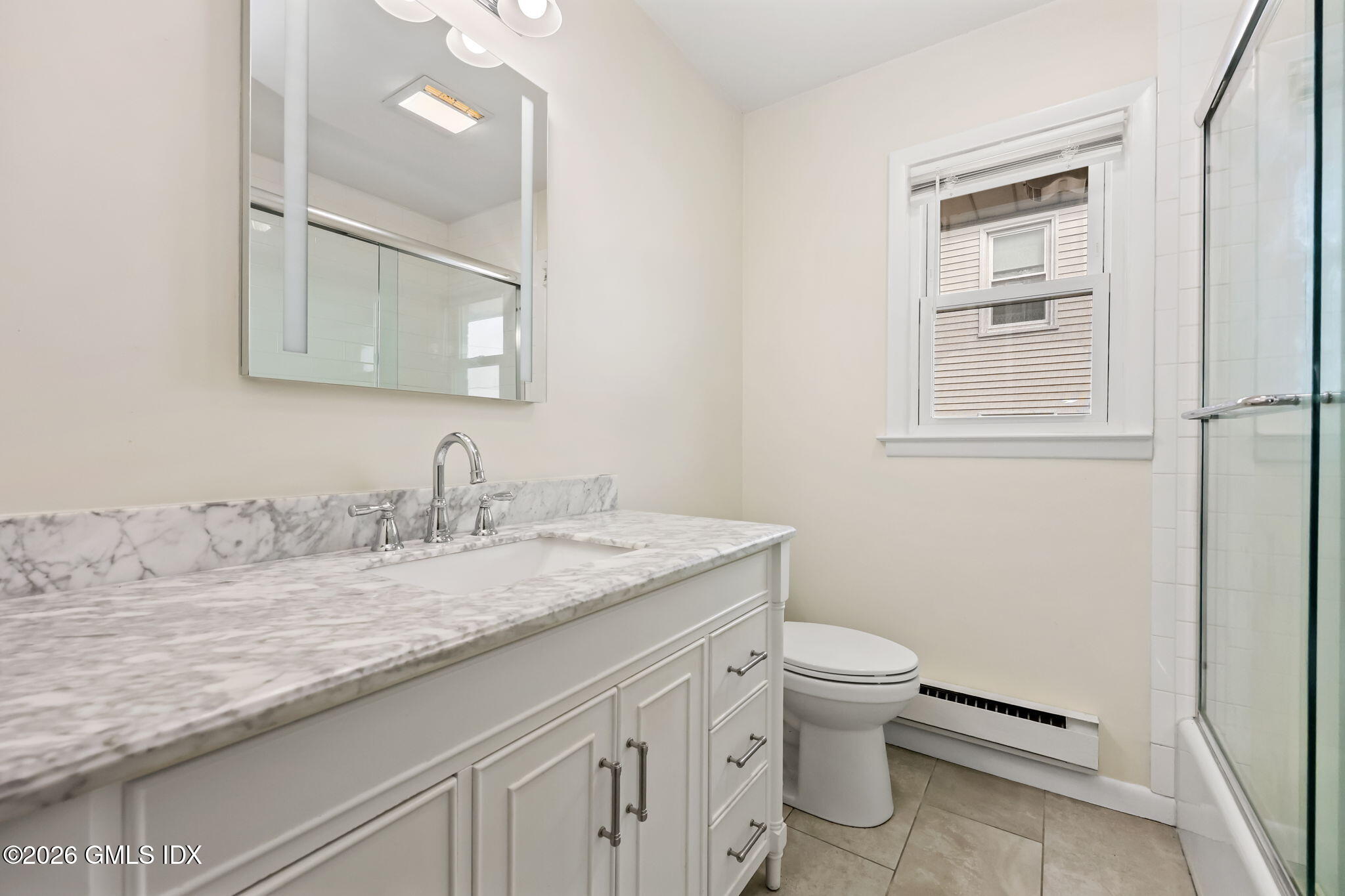 2 Grange Street Greenwich, CT 06830 - Photo 20 of 31 a bathroom with a granite countertop sink a toilet and a mirror