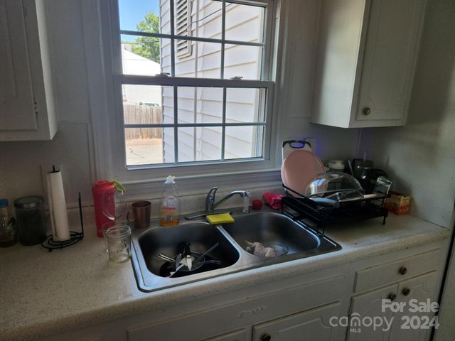 a kitchen with a sink appliances and cabinets
