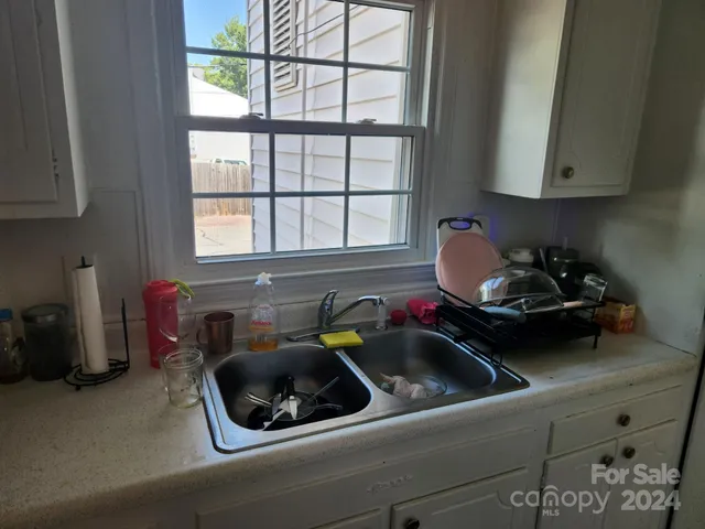 a kitchen with a sink appliances and cabinets