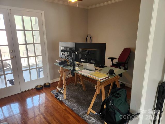 a view of a workspace with furniture and a window