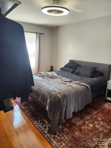 a bed sitting in a bedroom next to a window