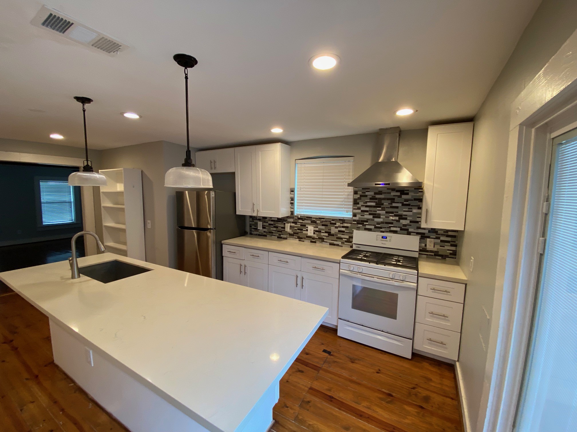 3209 Milburn Street Houston, TX 77021 - Photo 12 of 45 a kitchen with stainless steel appliances kitchen island a sink cabinets and refrigerator